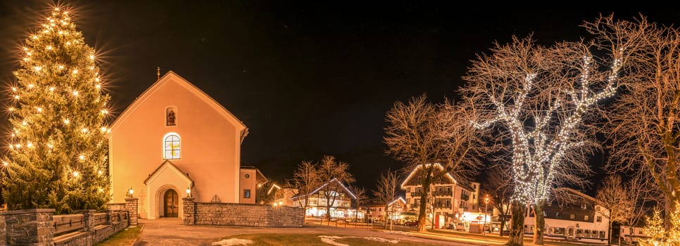 Night photography in the Ehrwald village, from Austria, during winter season, when all the buildings and trees are decorated with lights.