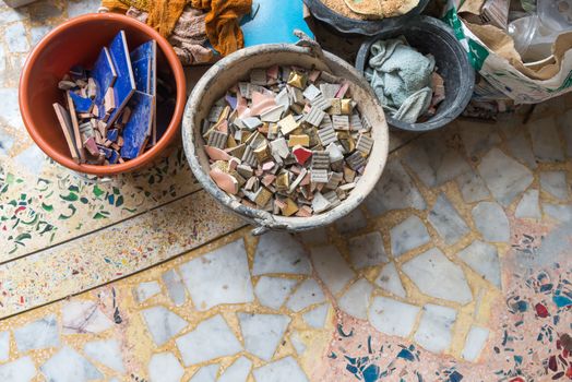 A decayed abandoned cement building mess with roof tiles only create an unorganized pattern