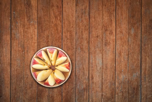 Top view of sliced apple on wooden background, stock photo