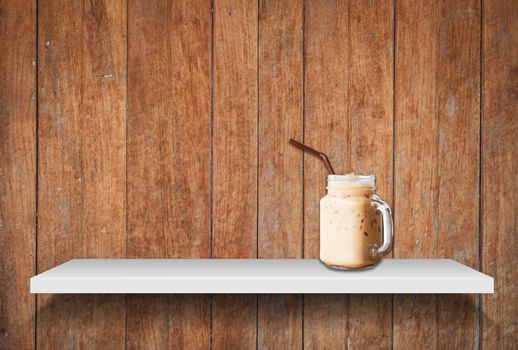 Iced coffee on shelf on old wooden background, stock photo
