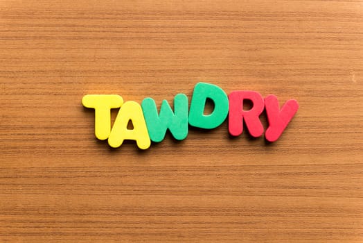 tawdry colorful word on the wooden background