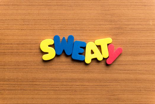 sweaty colorful word on the wooden background