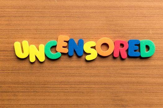 uncensored colorful word on the wooden background