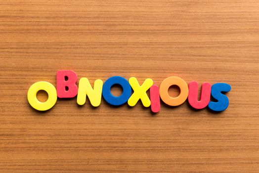 obnoxious colorful word on the wooden background