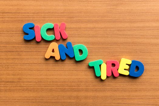 sick and tired colorful word on the wooden background