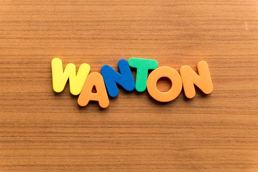 wanton colorful word on the wooden background