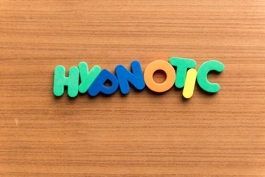 hypnotic colorful word on the wooden background