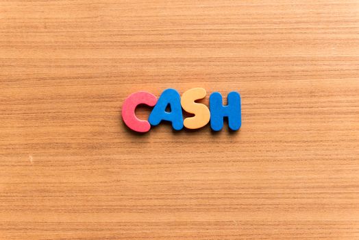 cash colorful word on the wooden background