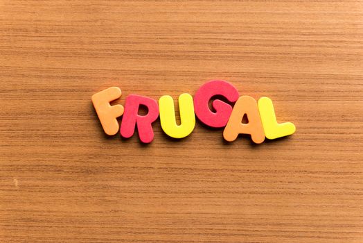 frugal colorful word on the wooden background
