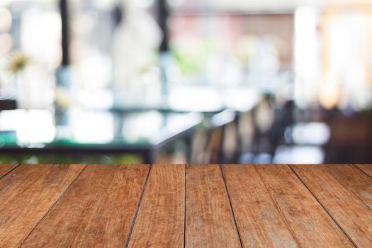 Empty wooden table and blurred cafe background, stock photo