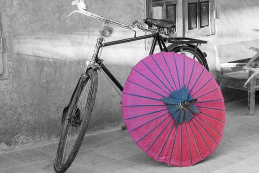 Retro bicycle with red umbrella, Color in black and white conceptual, idea. Vintage, retro style