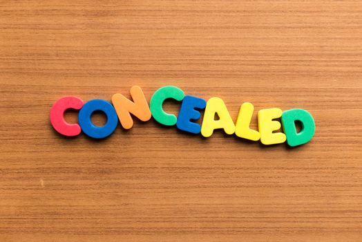 concealed colorful word on the wooden background