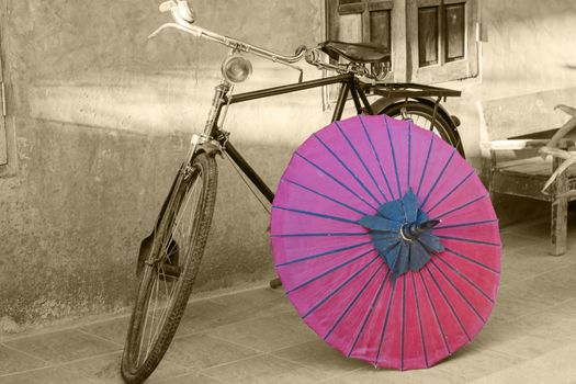 Retro bicycle with red umbrella, sepia conceptual, idea. Vintage, retro style