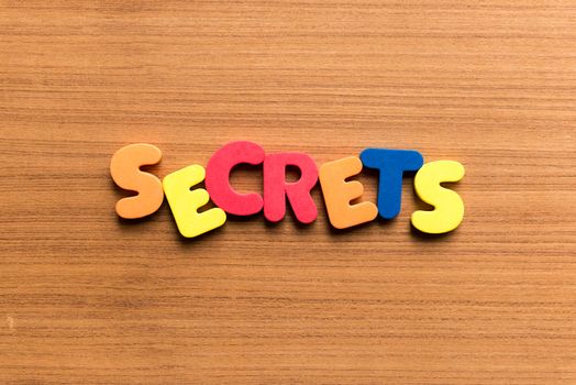 secrets colorful word on the wooden background