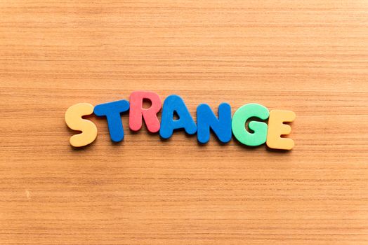 strange colorful word on the wooden background