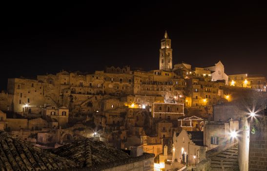 panoramic view of typical stones (Sassi di Matera) and church of Matera UNESCO European Capital of Culture 2019  at night 