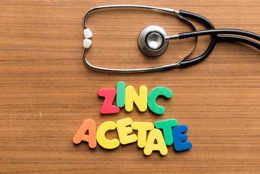 zinc acetate colorful word with stethoscope on wooden background