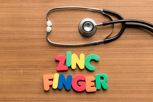 zinc finger colorful word with stethoscope on wooden background
