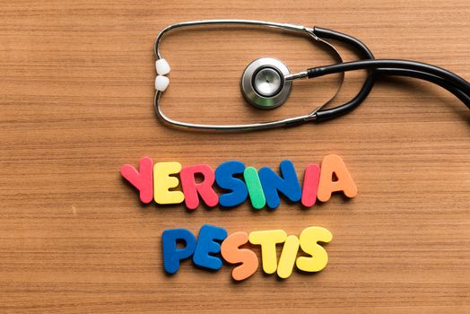 yersinia pestis colorful word with stethoscope on wooden background