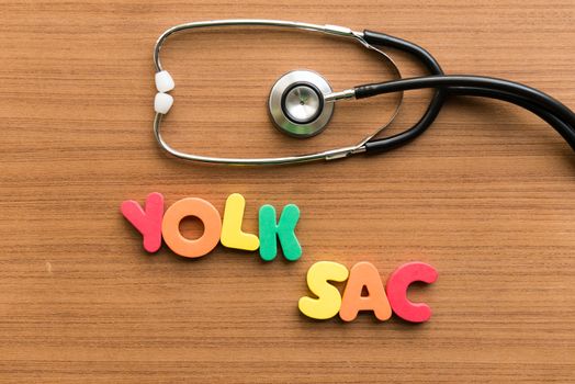 yolk sac colorful word with stethoscope on wooden background