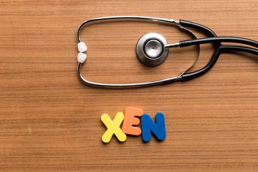 xen colorful word with stethoscope on wooden background