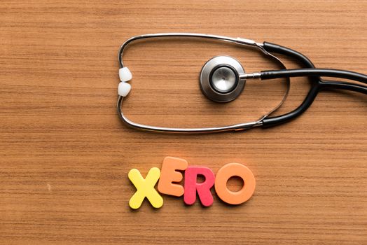 xero colorful word with stethoscope on wooden background