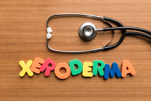 xeroderma colorful word with stethoscope on wooden background
