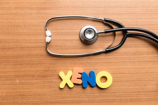 xeno colorful word with stethoscope on wooden background