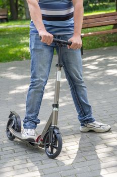 the photograph depicts a man on a scooter