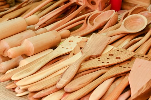 A collection of wooden kitchen utensils selling on market stall