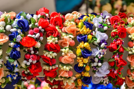 A very colorful floral headband selling on market stall.