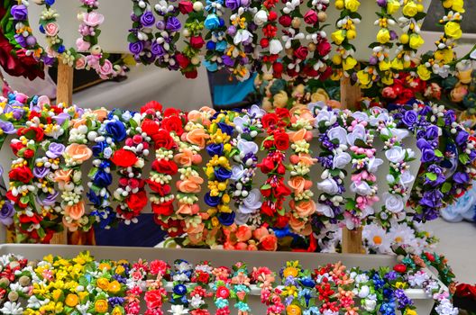 A very colorful floral headband selling on market stall.