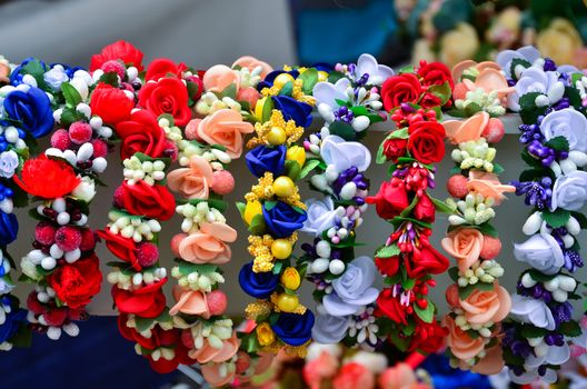 A very colorful floral headband selling on market stall.