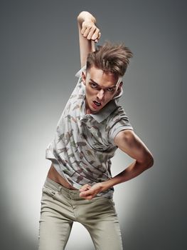 Emotional portrait of a teenager dancing on a gray background