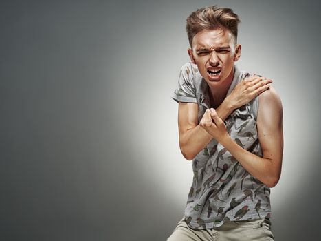 Emotional portrait of a teenager dancing on a gray background