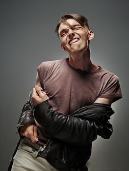 Emotional portrait of a teenager dancing on a gray background