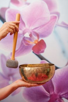 sound therapy: Woman with Tibetan singing bowl