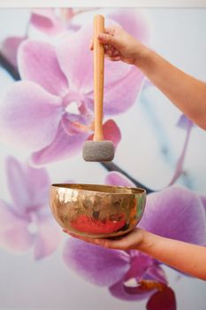 sound therapy: Woman with Tibetan singing bowl