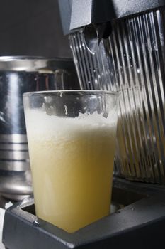 glass of fresh juice in juicer squeezer