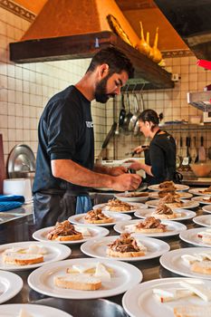 Tenerife, Spain, January 2015: Waiter prepare meals for customers on Bodega Monje- one of leading wine manufactures on north of Tenerife