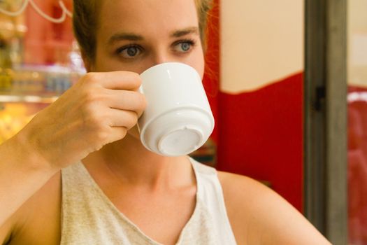 woman drinks coffee on ceramic cup