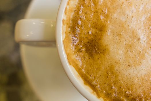 white ceramic cup with hot coffee  close up blurred