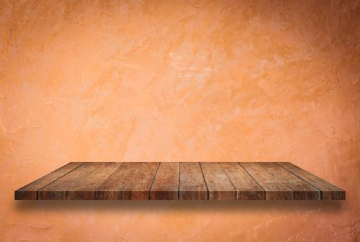 Empty perspective top wooden shelf on orange wall background