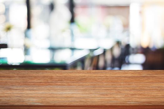 Top of wooden table with blurred cafe background, stock photo