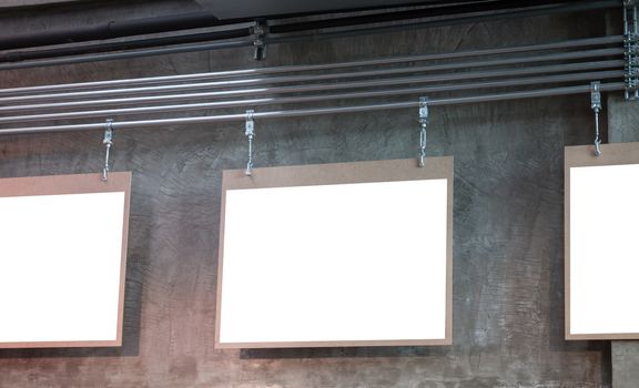 Hanging blank board with grey background, stock photo