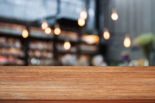 Top wooden table with cafe background, stock photo