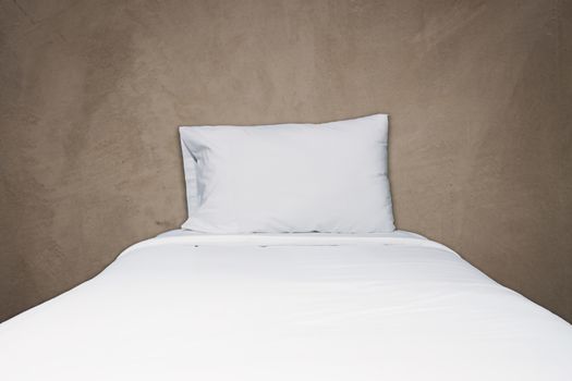 Close up white bedding and pillow on gray concrete texture background