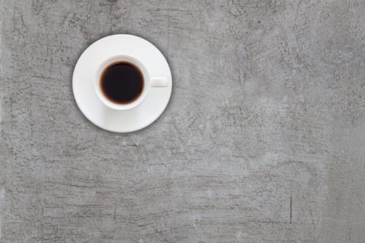 Top view of coffee cup on abstrsct gray concrete texture background