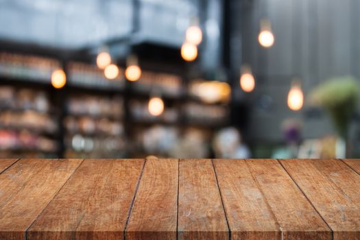 Perspective table top wooden with blurred cafe background. product display template