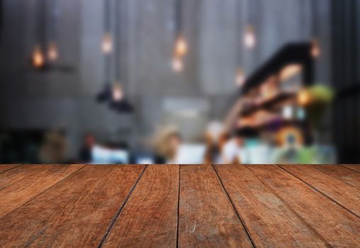 Perspective table top wooden with blurred coffee shop background. product display template